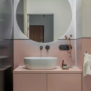 The bathroom is dominated by a combination of pink and white