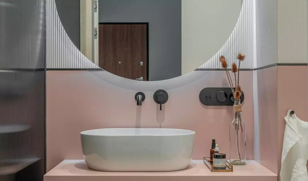 The bathroom is dominated by a combination of pink and white