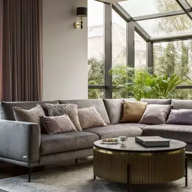 The comfortable corner is located next to large windows