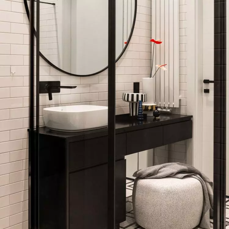 White bathroom features contrasting furnishings
