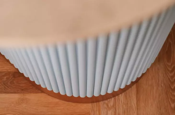 The kitchen peninsula has a fluted base