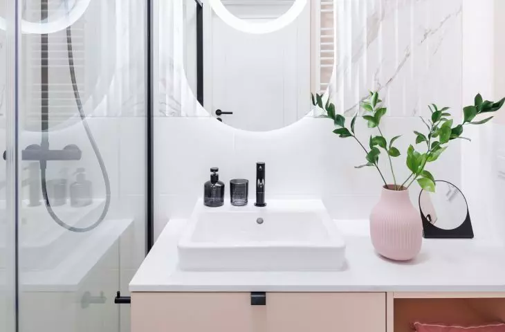 Large mirror and bright lighting optically enlarge the space