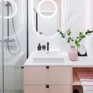 Large mirror and bright lighting optically enlarge the space