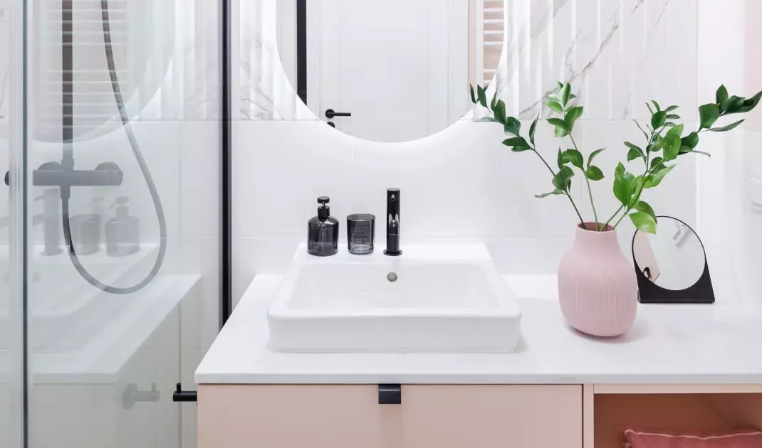 Large mirror and bright lighting optically enlarge the space