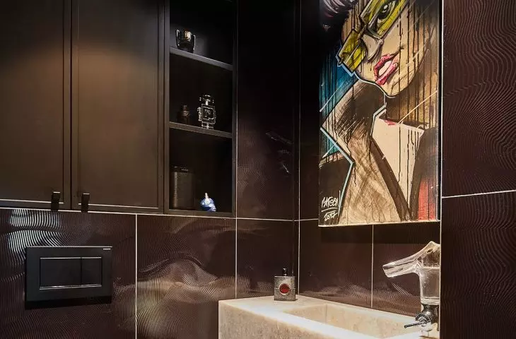 Above the sink is a cartoon graphic