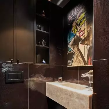 Above the sink is a cartoon graphic