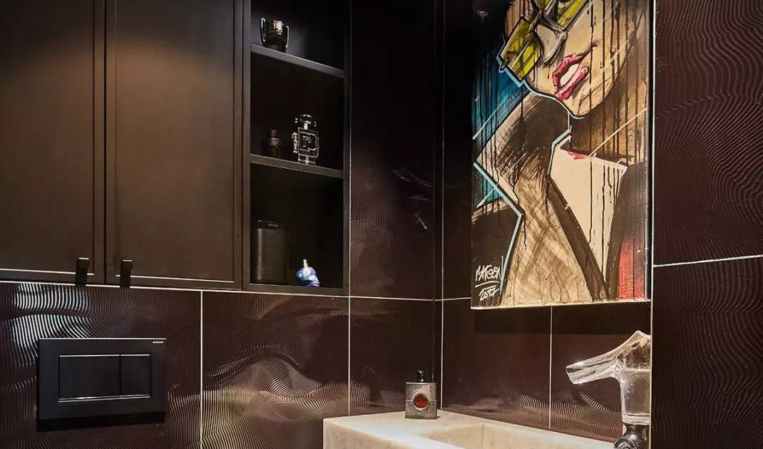 Above the sink is a cartoon graphic