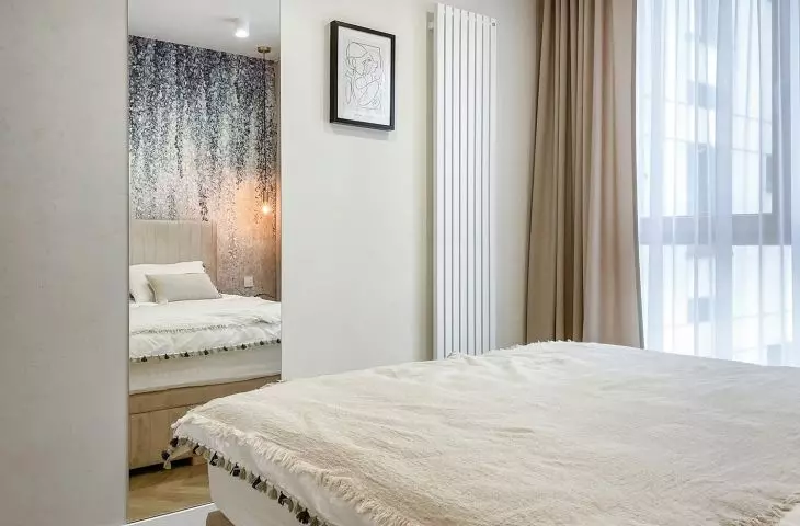 A large mirror panel illuminates and optically enlarges the space