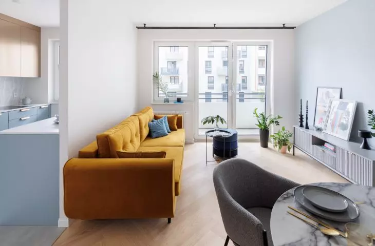 A bold accent in the living room is the yellow sofa 