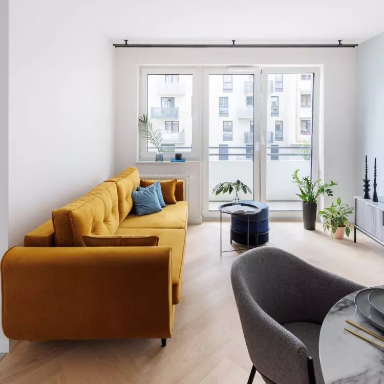 A bold accent in the living room is the yellow sofa 