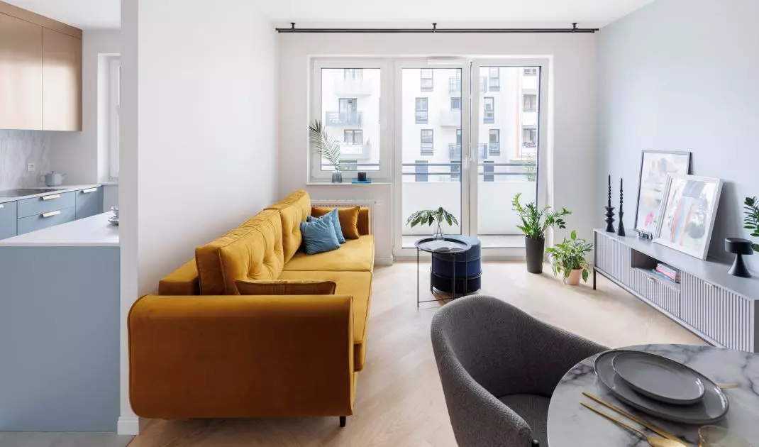 A bold accent in the living room is the yellow sofa 