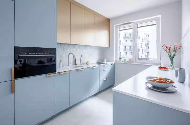 The kitchen cabinets relate in color to the living room