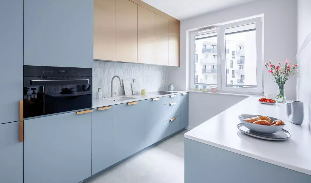 The kitchen cabinets relate in color to the living room
