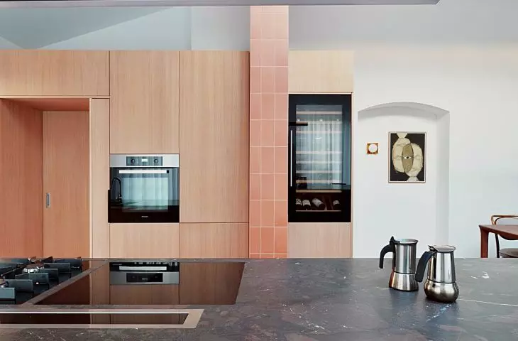 Cabinets hide the entrance to the pantry