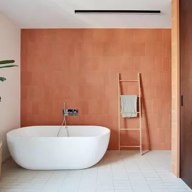 The bathroom uses stone