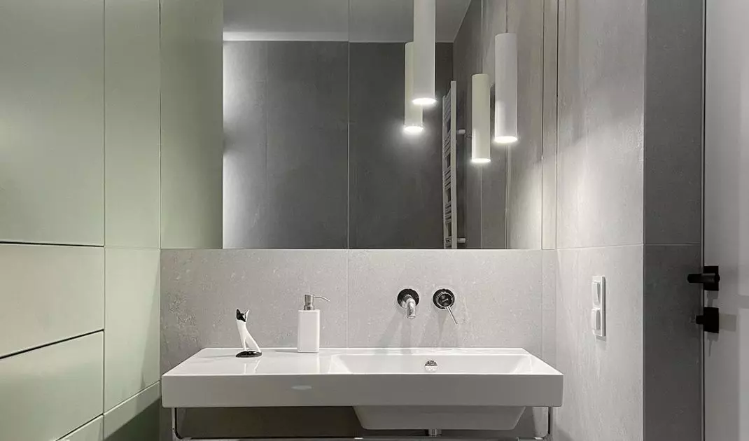 A small bathroom appears more spacious through the use of large mirrors