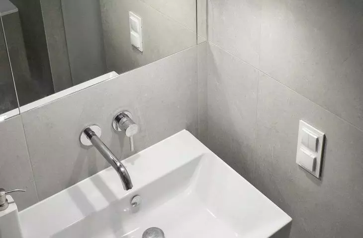 The lamps reflected in the mirror create an interesting visual effect