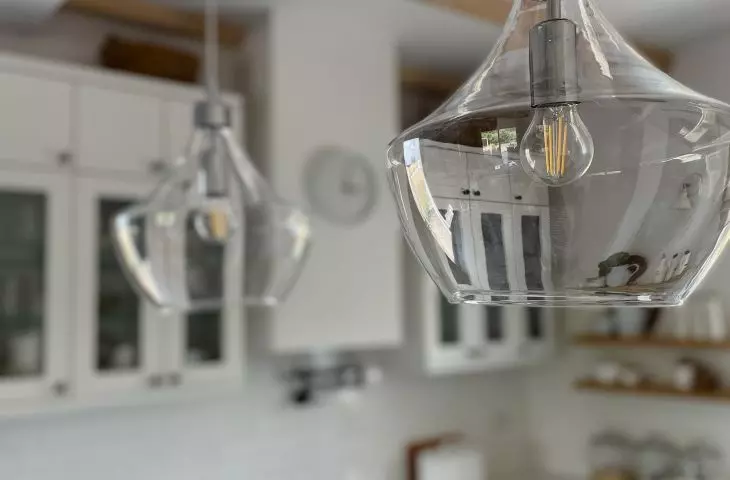 Two ornate lamps hang above the island