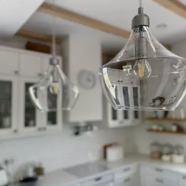 Two ornate lamps hang above the island