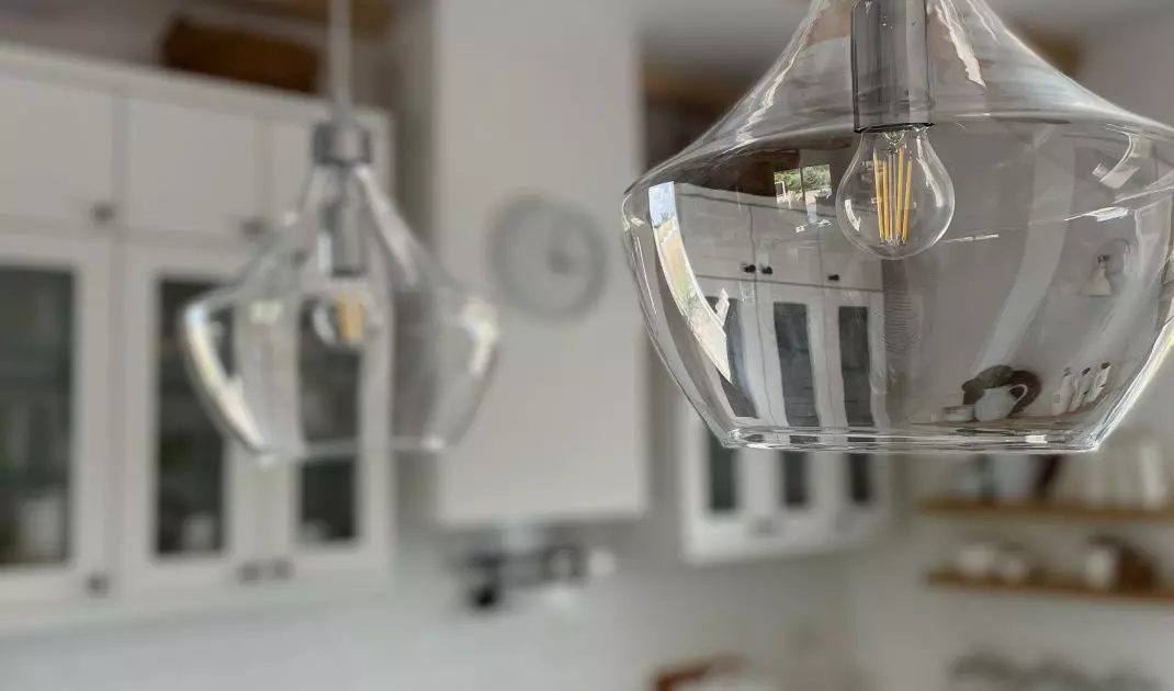 Two ornate lamps hang above the island