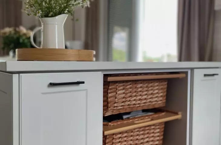 Drawers of the kitchen island form wicker baskets