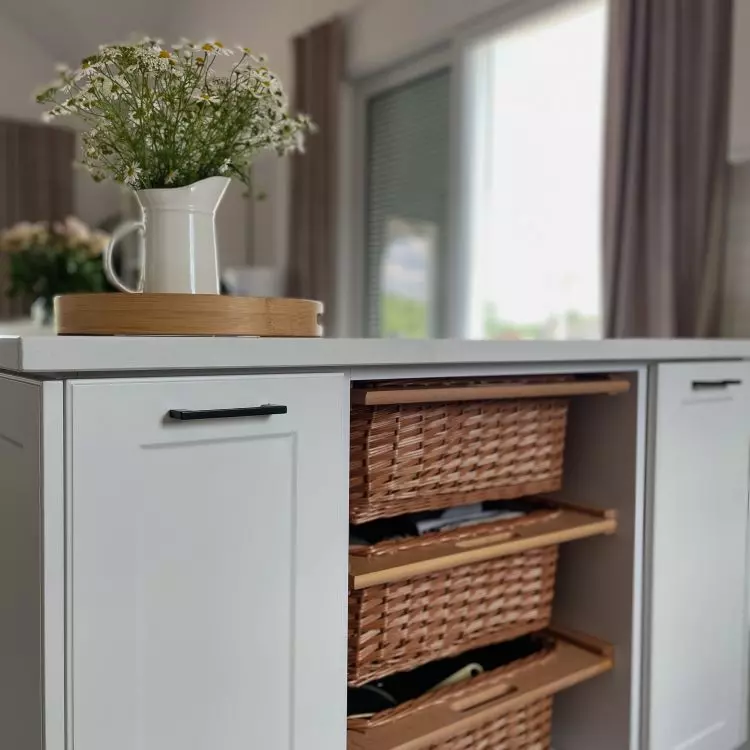 Drawers of the kitchen island form wicker baskets
