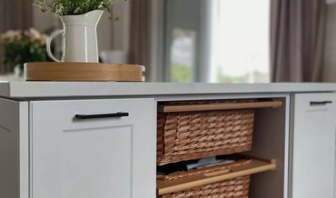 Drawers of the kitchen island form wicker baskets
