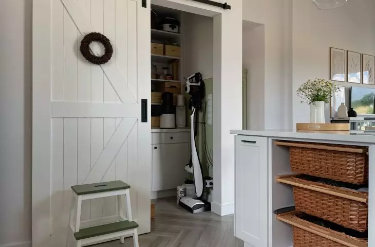 Behind the sliding door is a pantry
