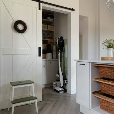 Behind the sliding door is a pantry