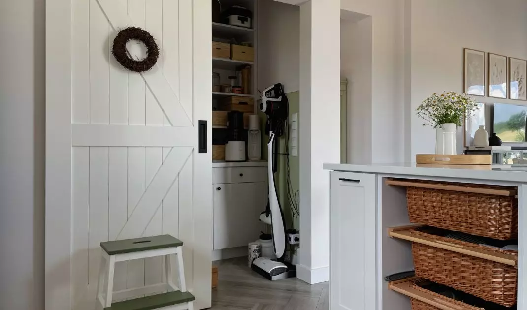 Behind the sliding door is a pantry