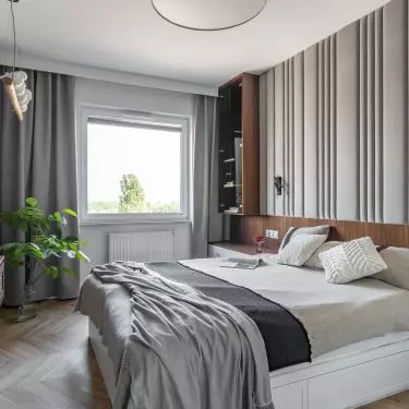 The wall with the TV in the bedroom was covered with structured wallpaper