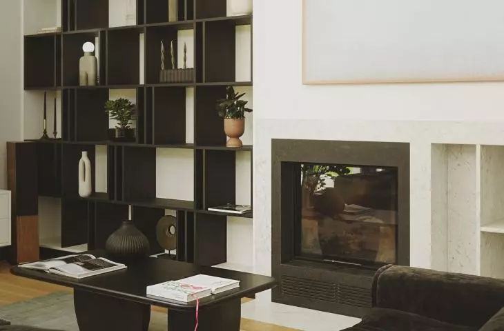 Black bookcase stands out against white wall
