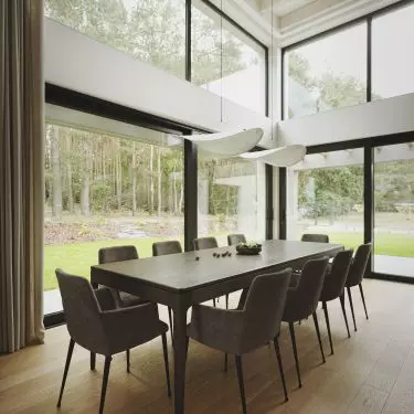 Through the large glass windows in the dining room we can admire the forest