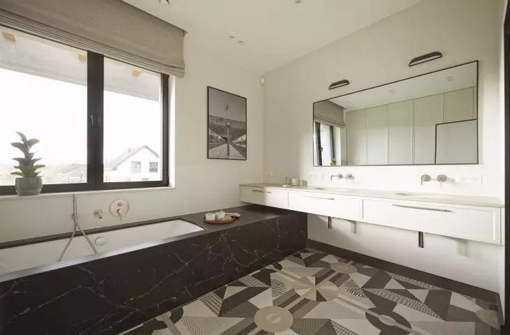 The bathroom floor was tiled in a geometric pattern