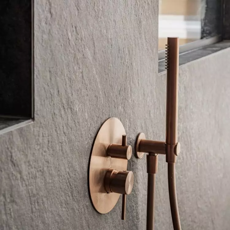 The shower area has been tiled with matte anthracite stoneware with a distinct texture