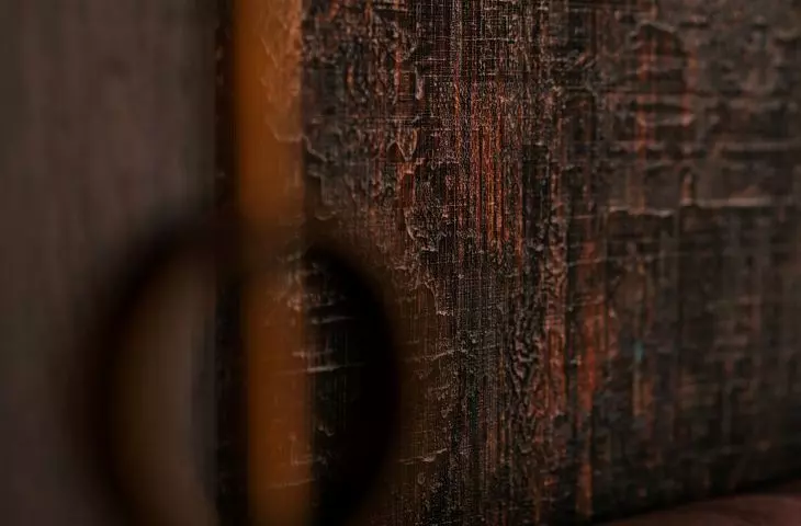 The bedroom is dominated by dark colors