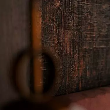 The bedroom is dominated by dark colors