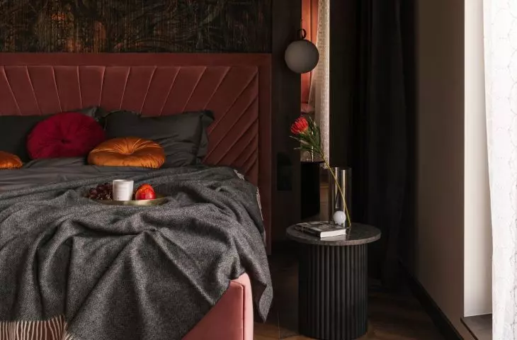Copper fronts correspond with the wallpaper behind the bed