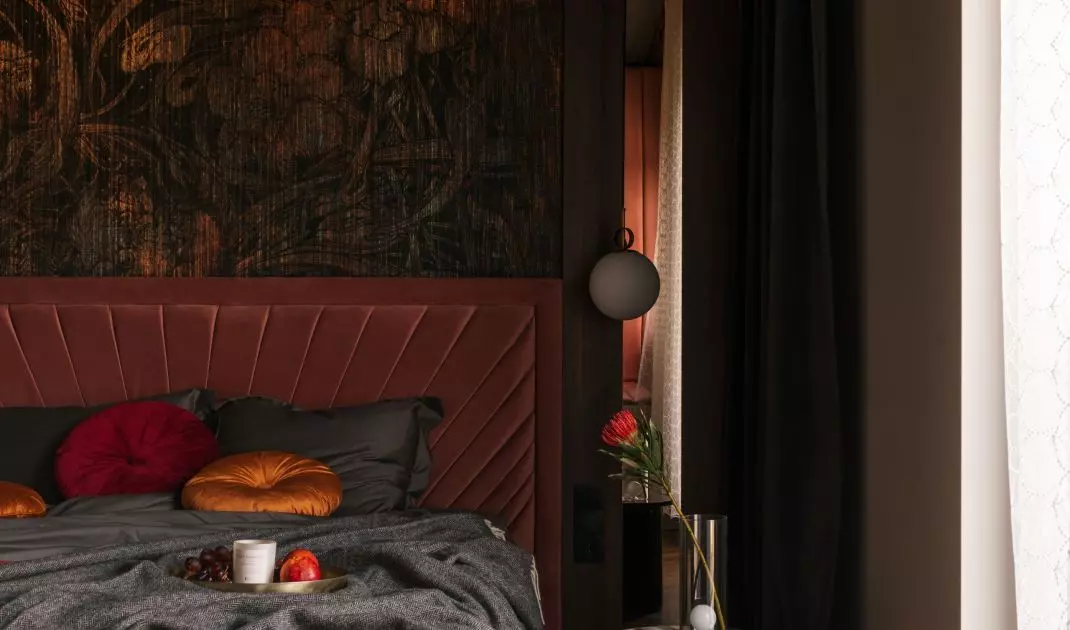 Copper fronts correspond with the wallpaper behind the bed