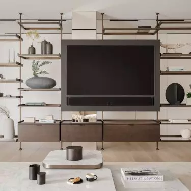 The sculptural bookcase in the living room was made of brass patinated bronze