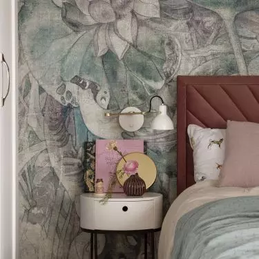The wall behind the bed is decorated with wallpaper in pastel flowers
