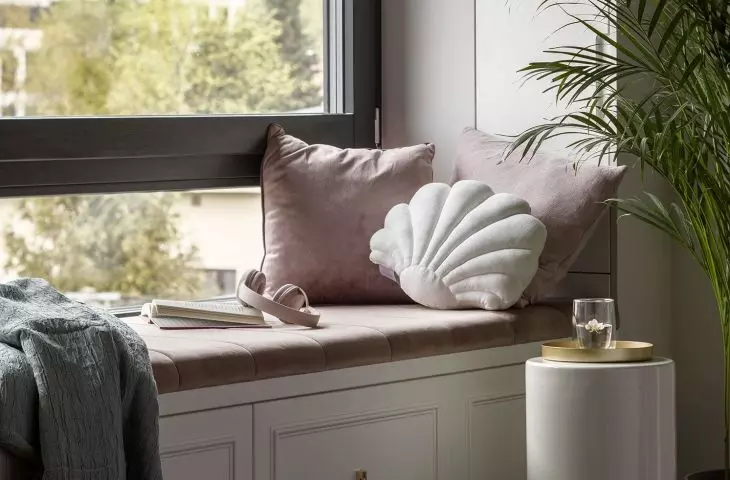 Under the window there is a comfortable seat