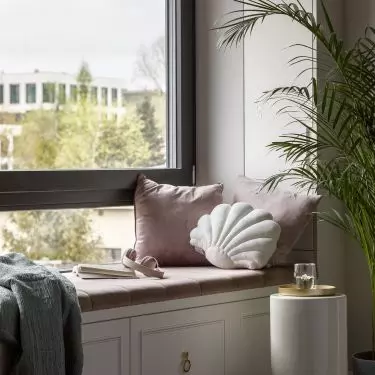 Under the window there is a comfortable seat