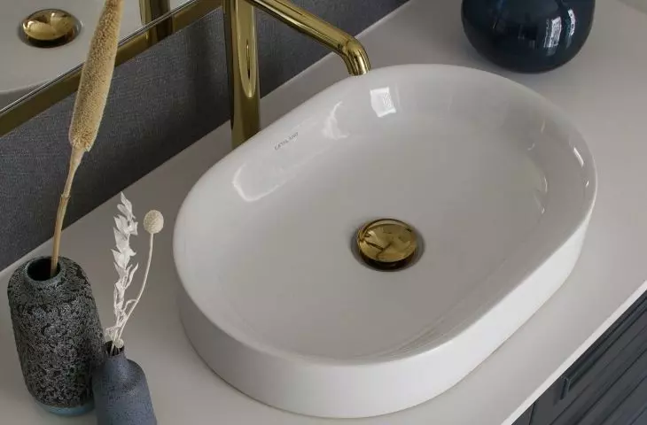 White countertops contrast with navy blue fronts