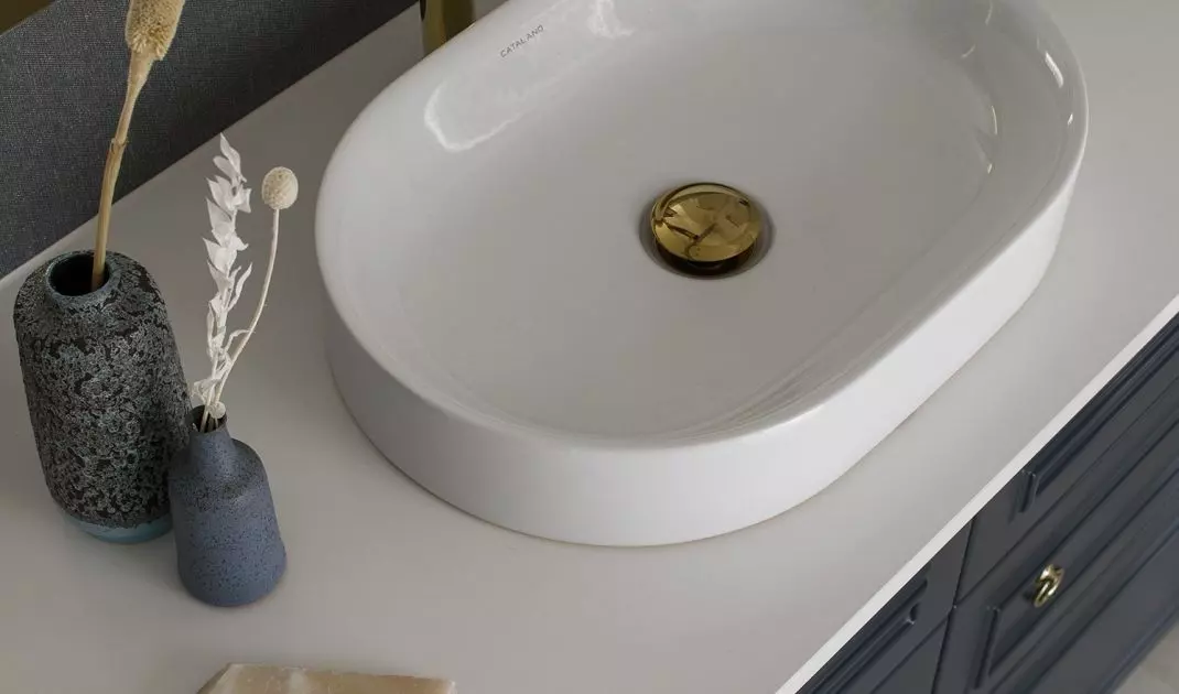 White countertops contrast with navy blue fronts