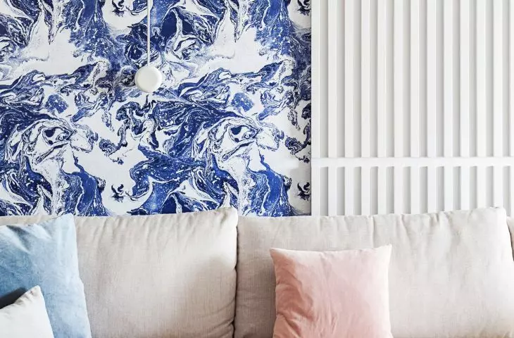 The wallpaper behind the sofa refers to the nearby sea