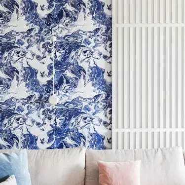 The wallpaper behind the sofa refers to the nearby sea