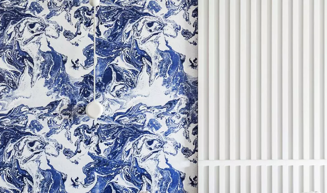 The wallpaper behind the sofa refers to the nearby sea
