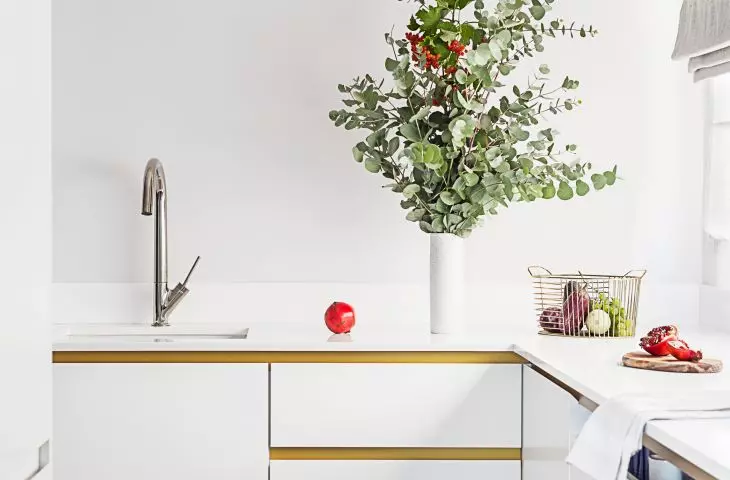 The white kitchen cabinets were complemented with gold details