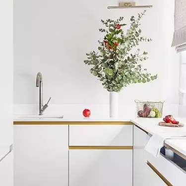 The white kitchen cabinets were complemented with gold details